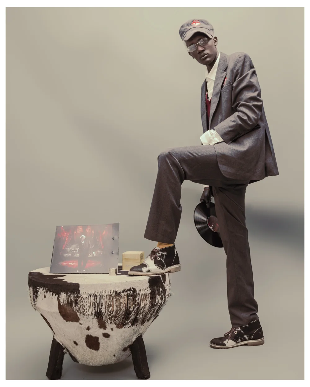 4Mr Frank White in a suit and cap, holding a vinyl record